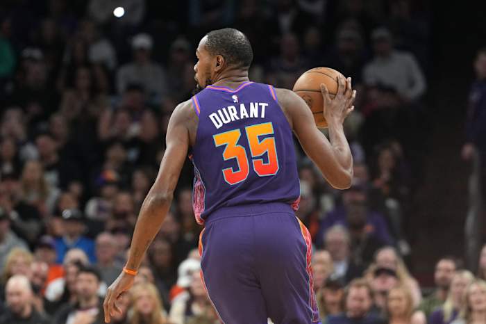 Phoenix Suns forward Kevin Durant (35) dribbles against the Charlotte Hornets during the first half at Footprint Center.